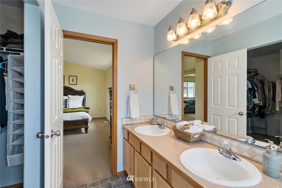 3530 186th Place Southeast Bothell, WA 98012 - Photo 25 of 38 a en suite bathroom with a double vanity sink and a mirror