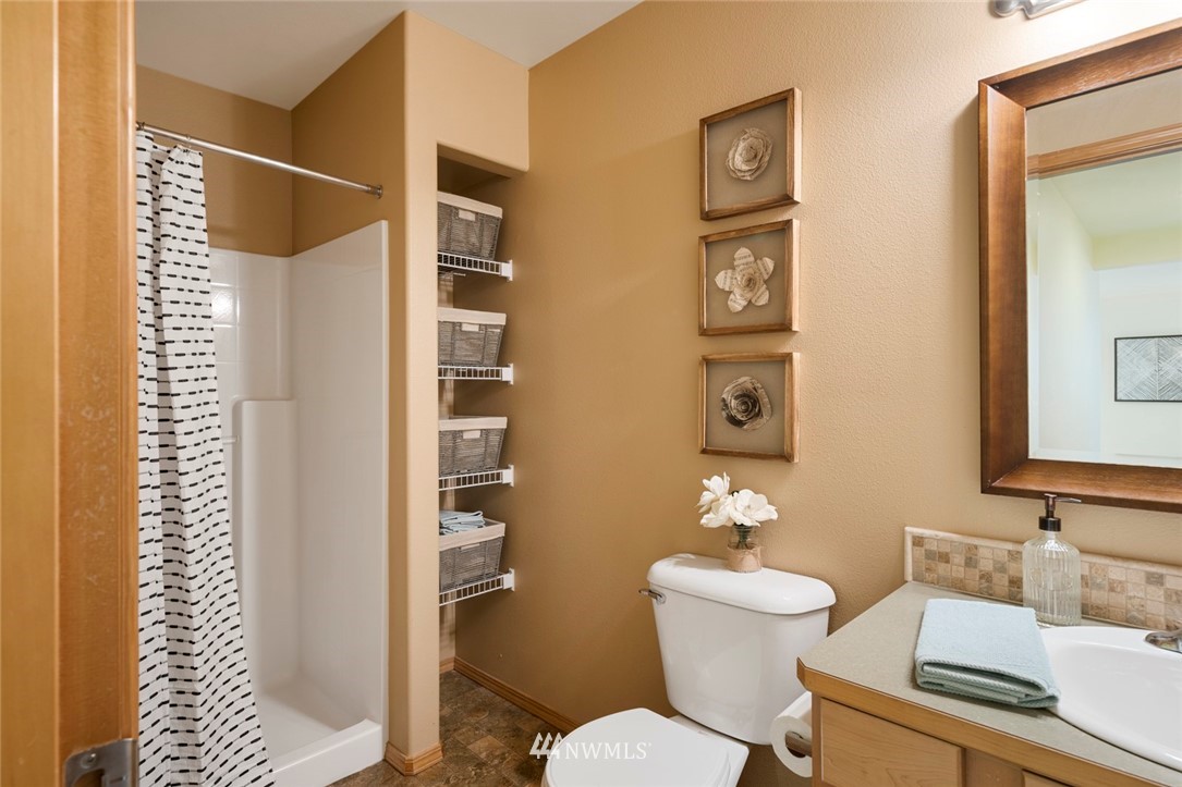 3530 186th Place Southeast Bothell, WA 98012 - Photo 31 of 38 a bathroom with a toilet a sink and mirror