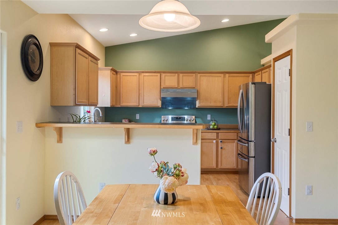 3530 186th Place Southeast Bothell, WA 98012 - Photo 8 of 38 a kitchen with stainless steel appliances granite countertop a refrigerator and a sink