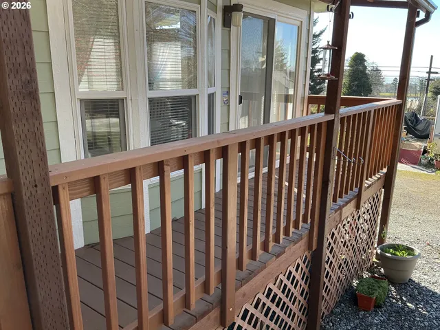a view of a balcony with wooden floor