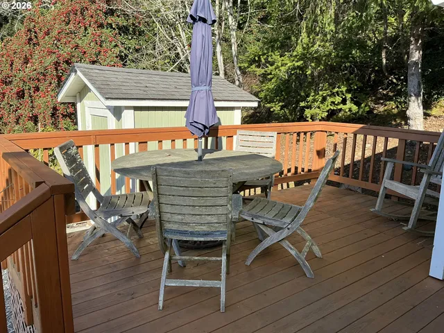 a view of a balcony with chairs and wooden floor