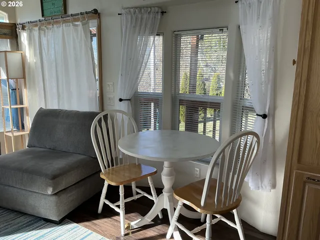 a view of a dining room with furniture and a window