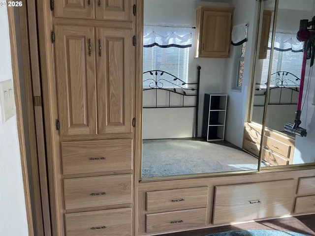 a view of kitchen with refrigerator and stove