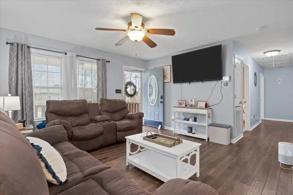 a living room with furniture and a flat screen tv
