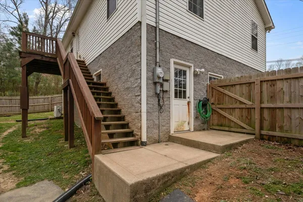 a view of backyard with deck and wooden floor