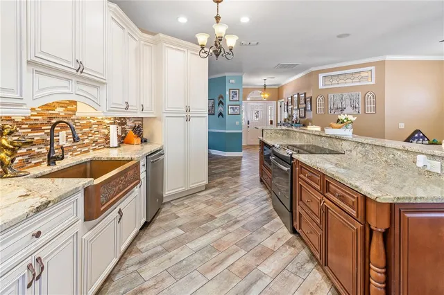 a kitchen with stainless steel appliances a refrigerator sink and cabinets