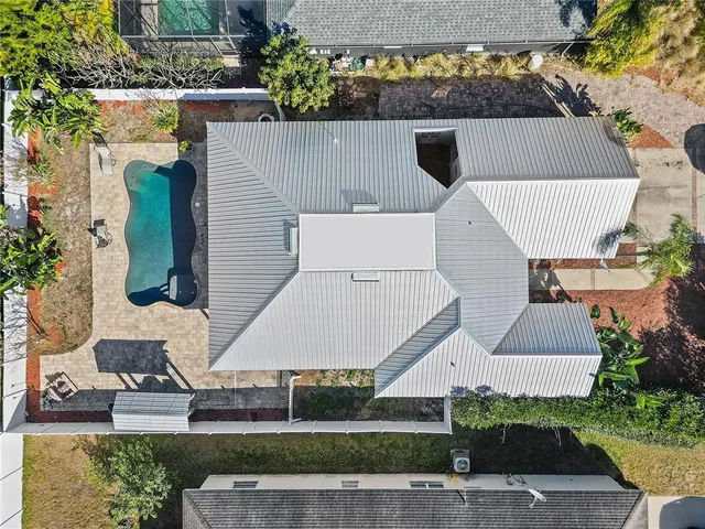 an aerial view of a house with a yard