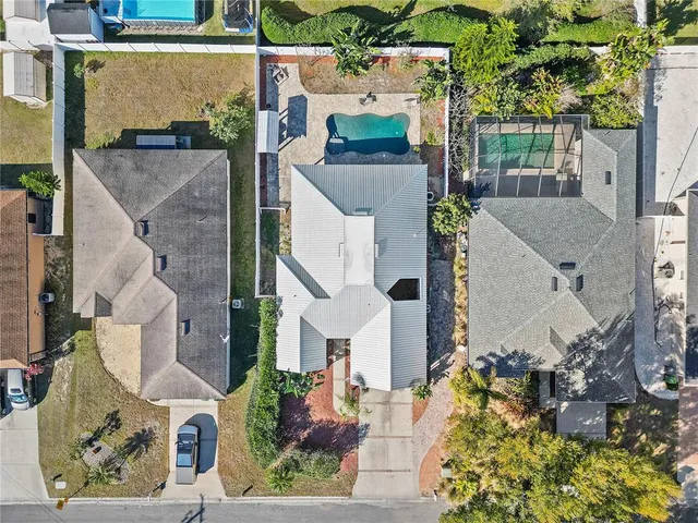 an aerial view of residential houses with outdoor space
