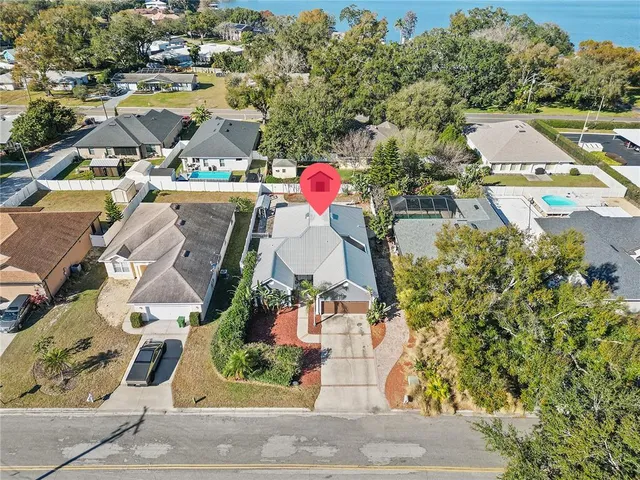 an aerial view of a house with yard swimming pool and outdoor seating