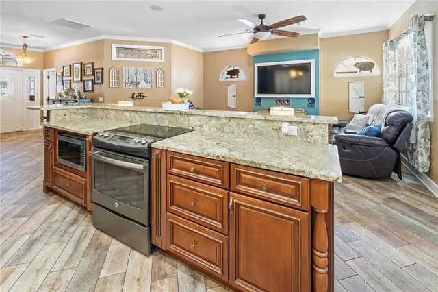 a kitchen with granite countertop white cabinets and stainless steel appliances