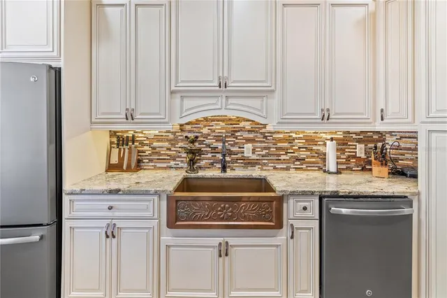 a kitchen with stainless steel appliances granite countertop a sink and a stove