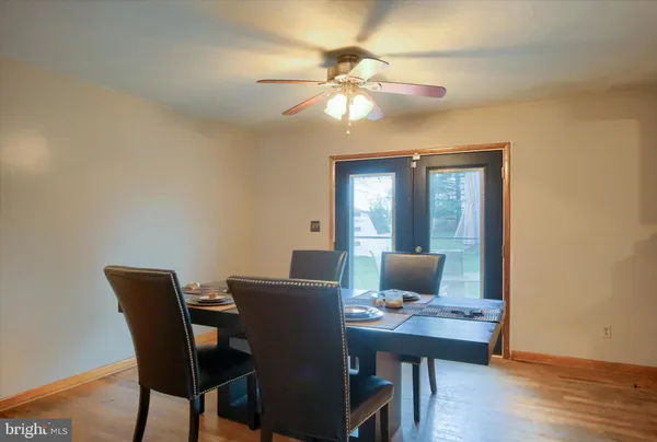 a view of a dining room with a table and chairs