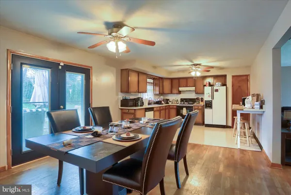 a view of a dining room with furniture and wooden floor