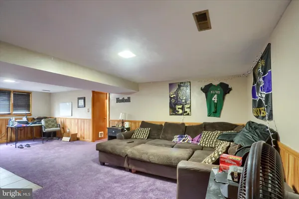 a living room with furniture and a walk in closet