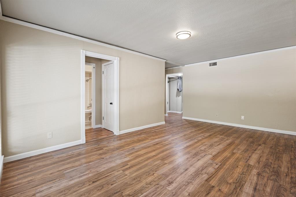 5634 Boca Raton Boulevard, Unit 209 Fort Worth, TX 76112 - Photo 6 of 24 a view of an empty room with wooden floor