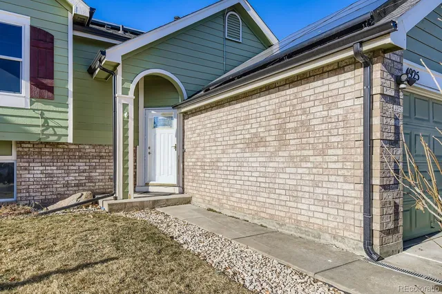 a front view of a house with a gate