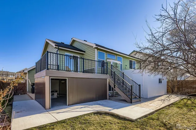 a view of house with roof deck and furniture