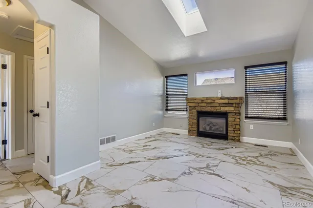 a view of an empty room with a fireplace