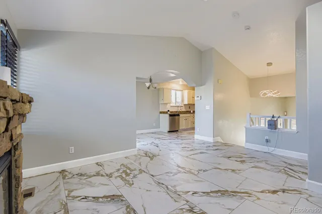 a view of a bedroom with a bed and wooden floor