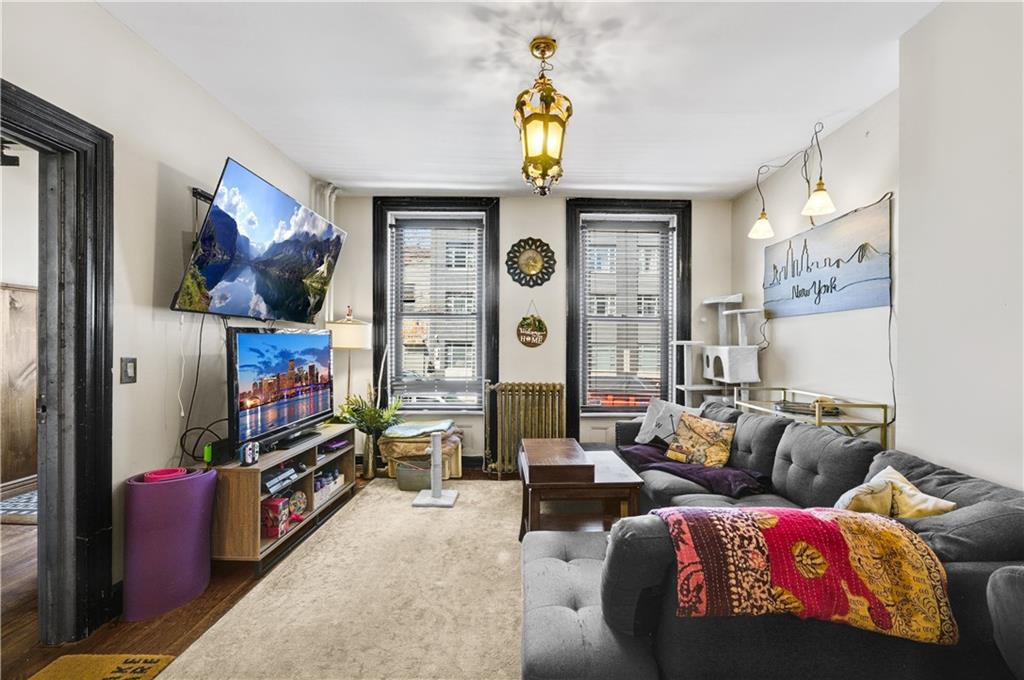 1030 Greene Avenue Brooklyn, NY 11221 - Photo 11 of 19 a living room with furniture a window and a flat screen tv