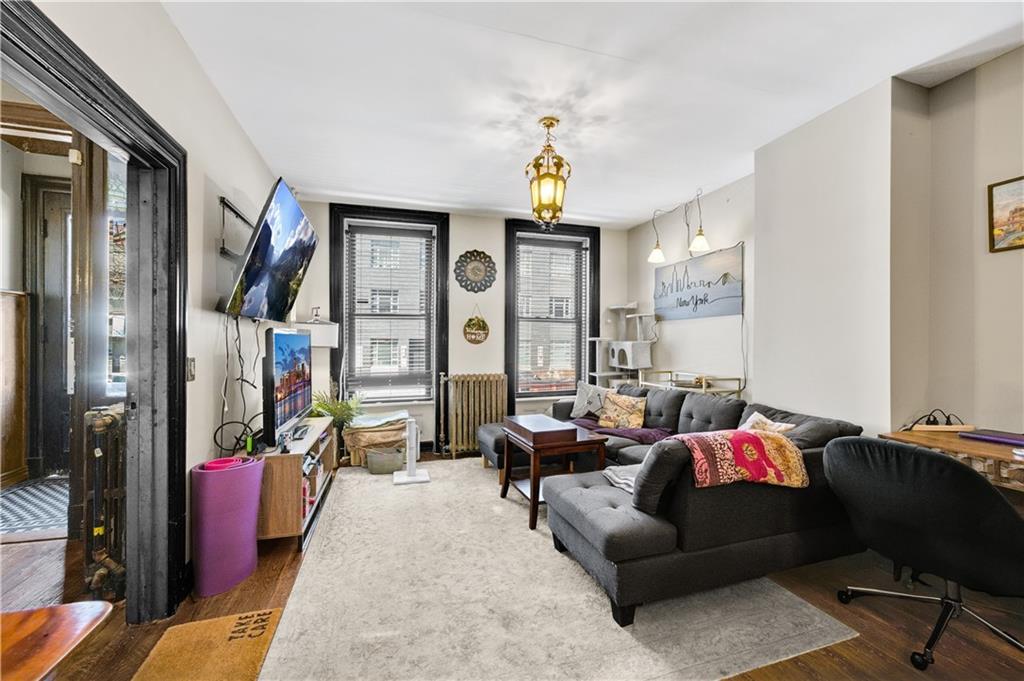 1030 Greene Avenue Brooklyn, NY 11221 - Photo 12 of 19 a living room with furniture chess board and a window