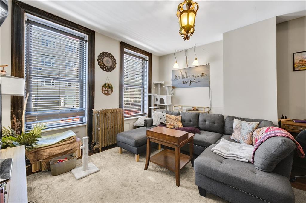 1030 Greene Avenue Brooklyn, NY 11221 - Photo 13 of 19 a living room with furniture and a window