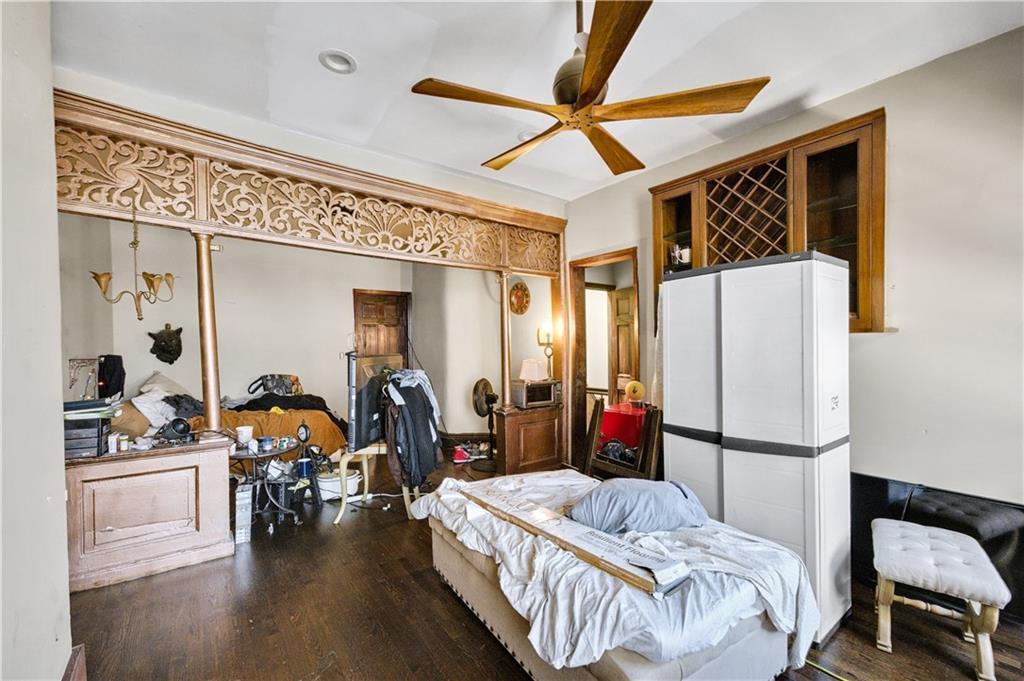 1030 Greene Avenue Brooklyn, NY 11221 - Photo 17 of 19 a bedroom with furniture and a chandelier