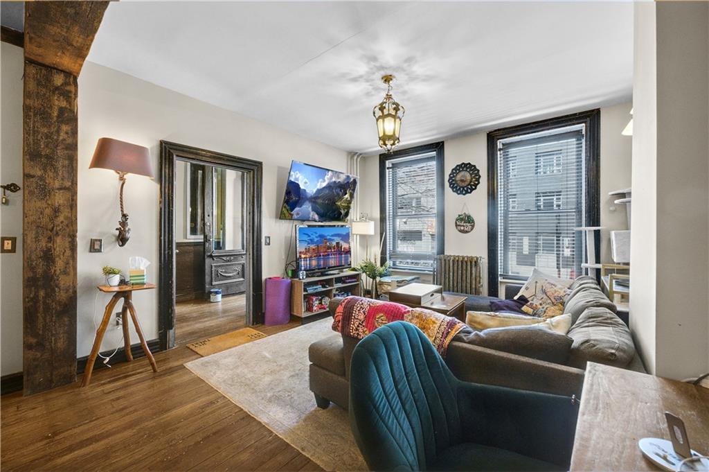 1030 Greene Avenue Brooklyn, NY 11221 - Photo 18 of 19 a living room with furniture and a window