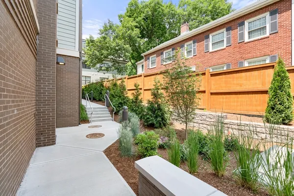 a view of a patio with a dining table and chairs with wooden floor
