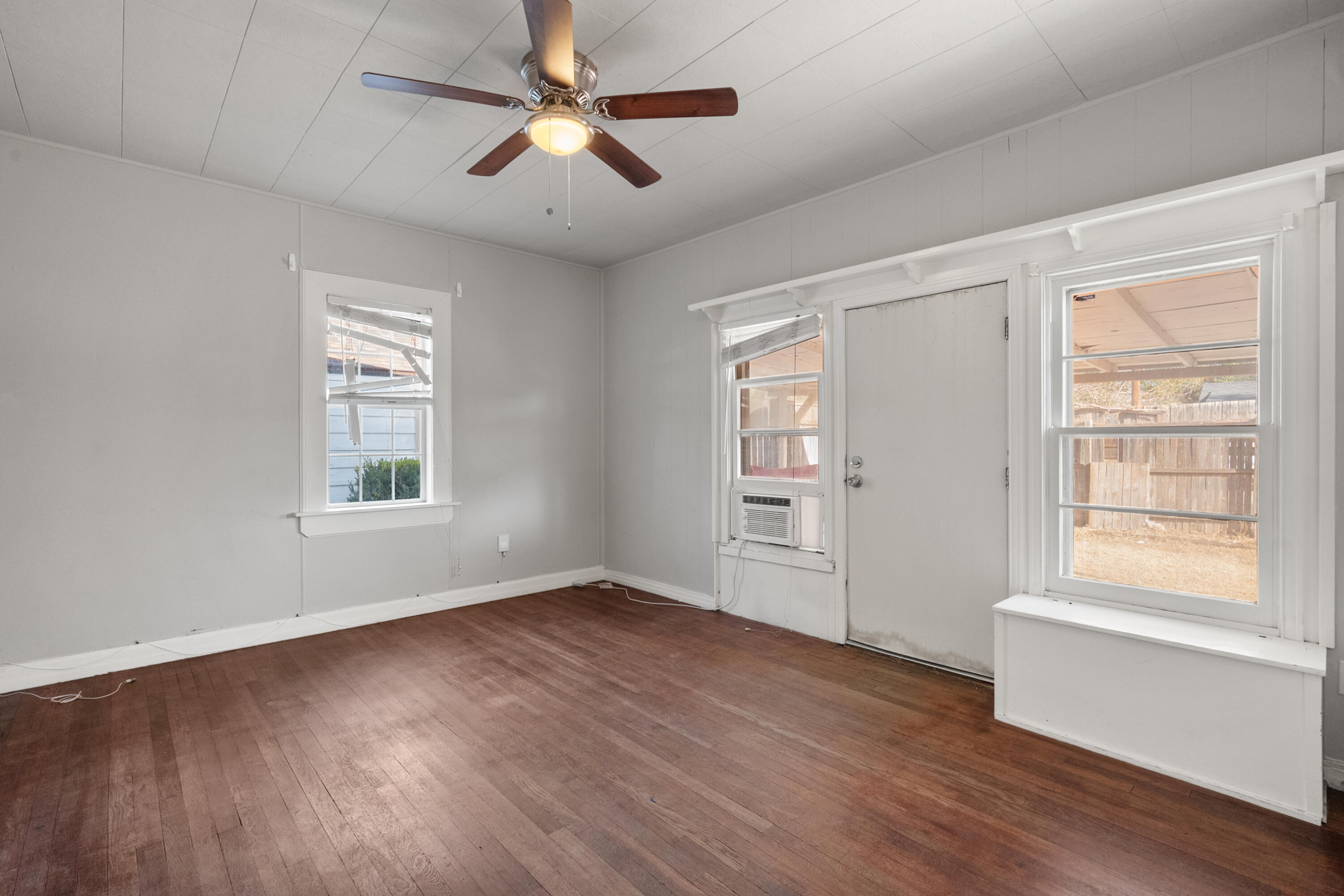 2102 25th Street Lubbock, TX 79411 - Photo 7 of 11 a view of empty room with wooden floor and fan