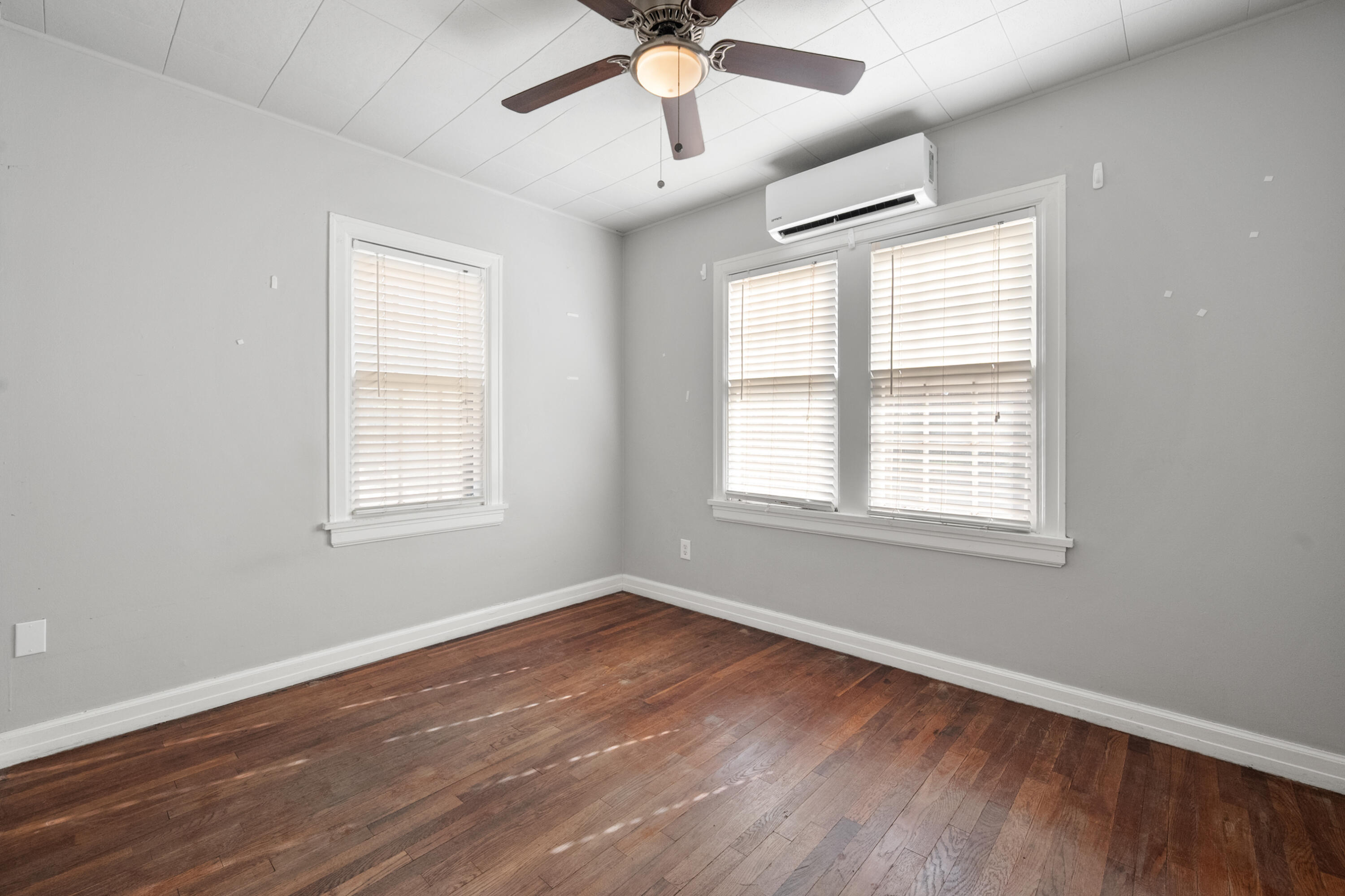 2102 25th Street Lubbock, TX 79411 - Photo 8 of 11 a view of an empty room with wooden floor and a window