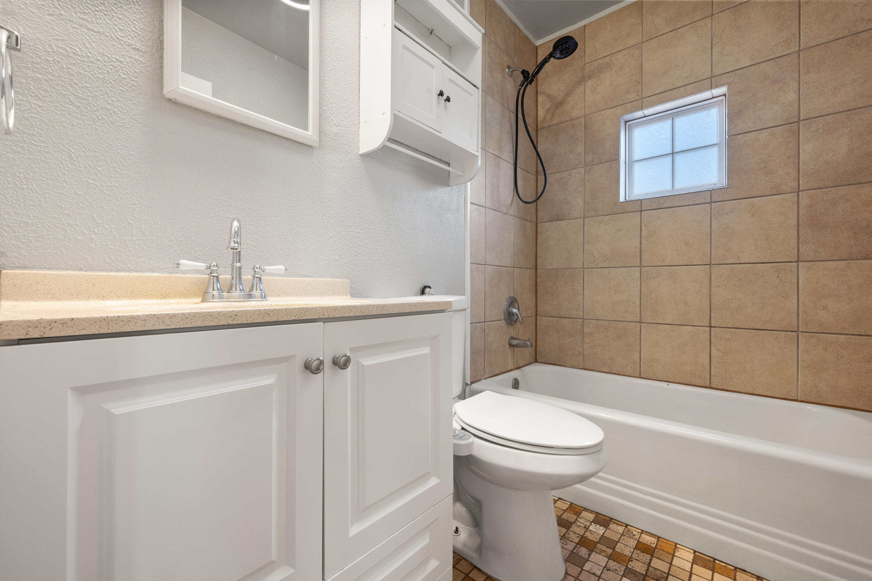 2102 25th Street Lubbock, TX 79411 - Photo 10 of 11 a bathroom with a sink a toilet and shower