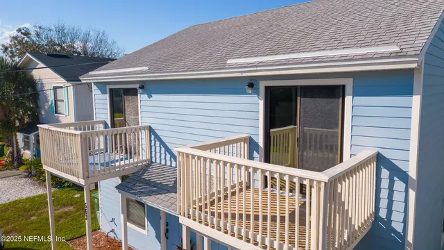 a view of a house with wooden deck and backyard