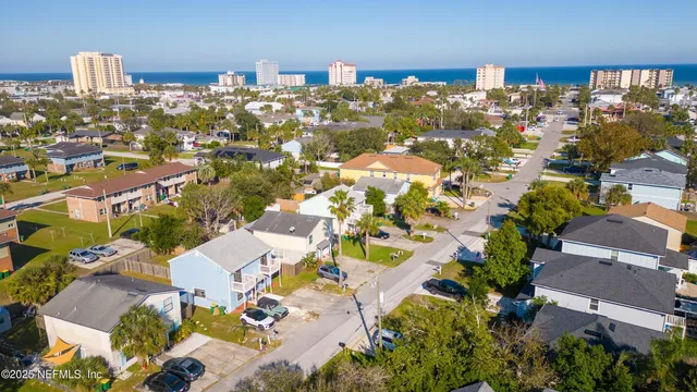 an aerial view of residential building with parking