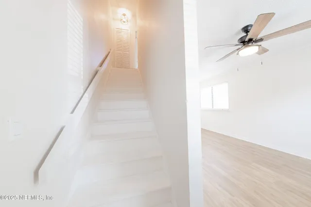 a view of entryway and hall with wooden floor