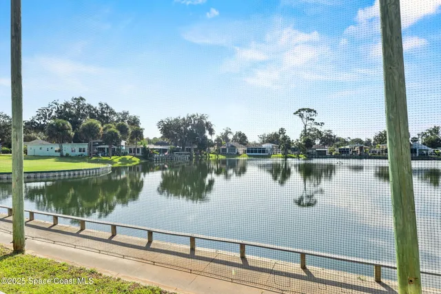 a living room with furniture chandelier and a window