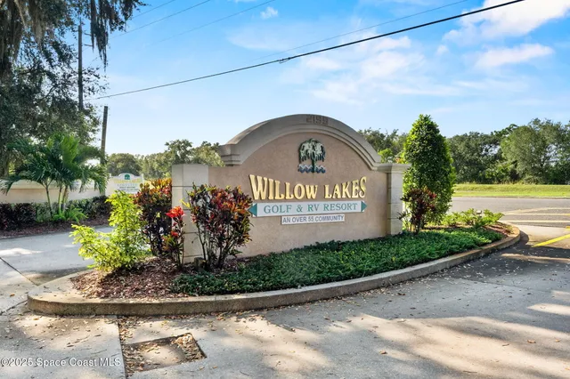 an aerial view of a houses with swimming pool and lake view
