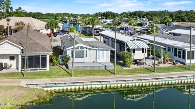an aerial view of a house with a lake view