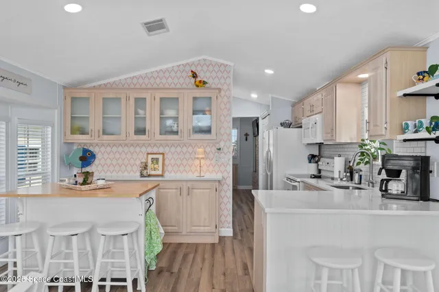 a living room with furniture a ceiling fan and a window