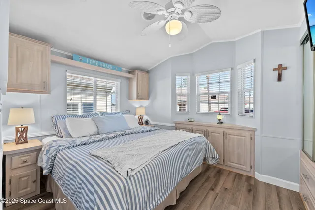 a living room with furniture and a ceiling fan