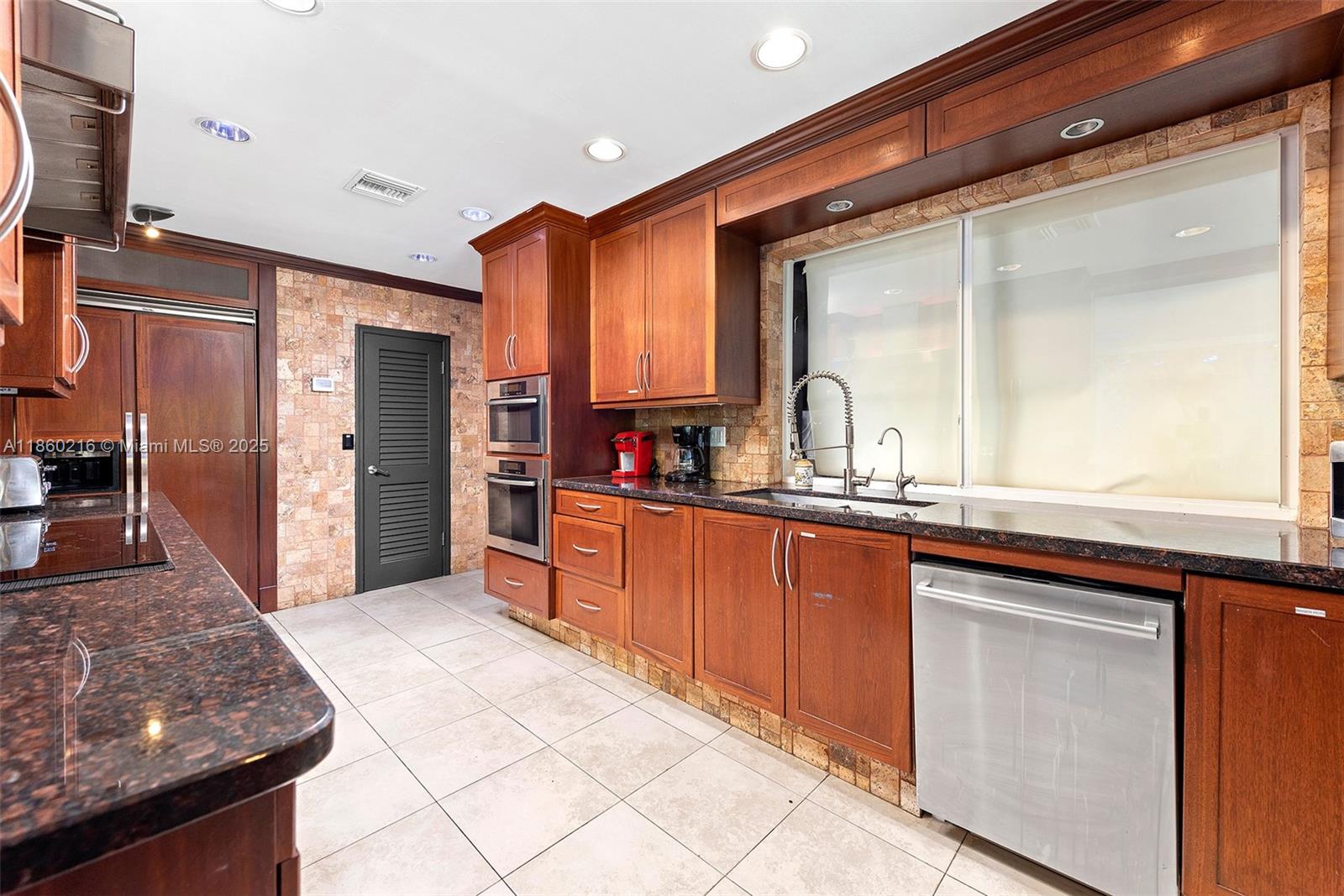 250 Northeast 158th Street Miami, FL 33162 - Photo 14 of 80 a kitchen with stainless steel appliances granite countertop a refrigerator and a sink