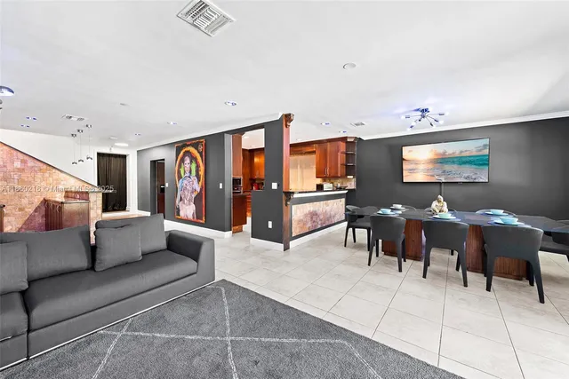 a bedroom with a bed and a lamp on dresser