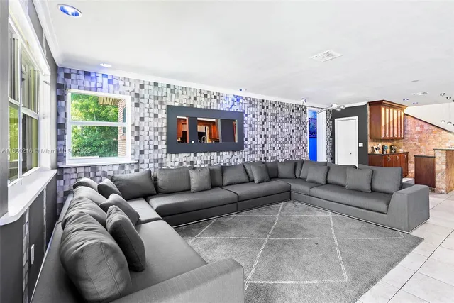 a bedroom with a bed and a lamp on dresser