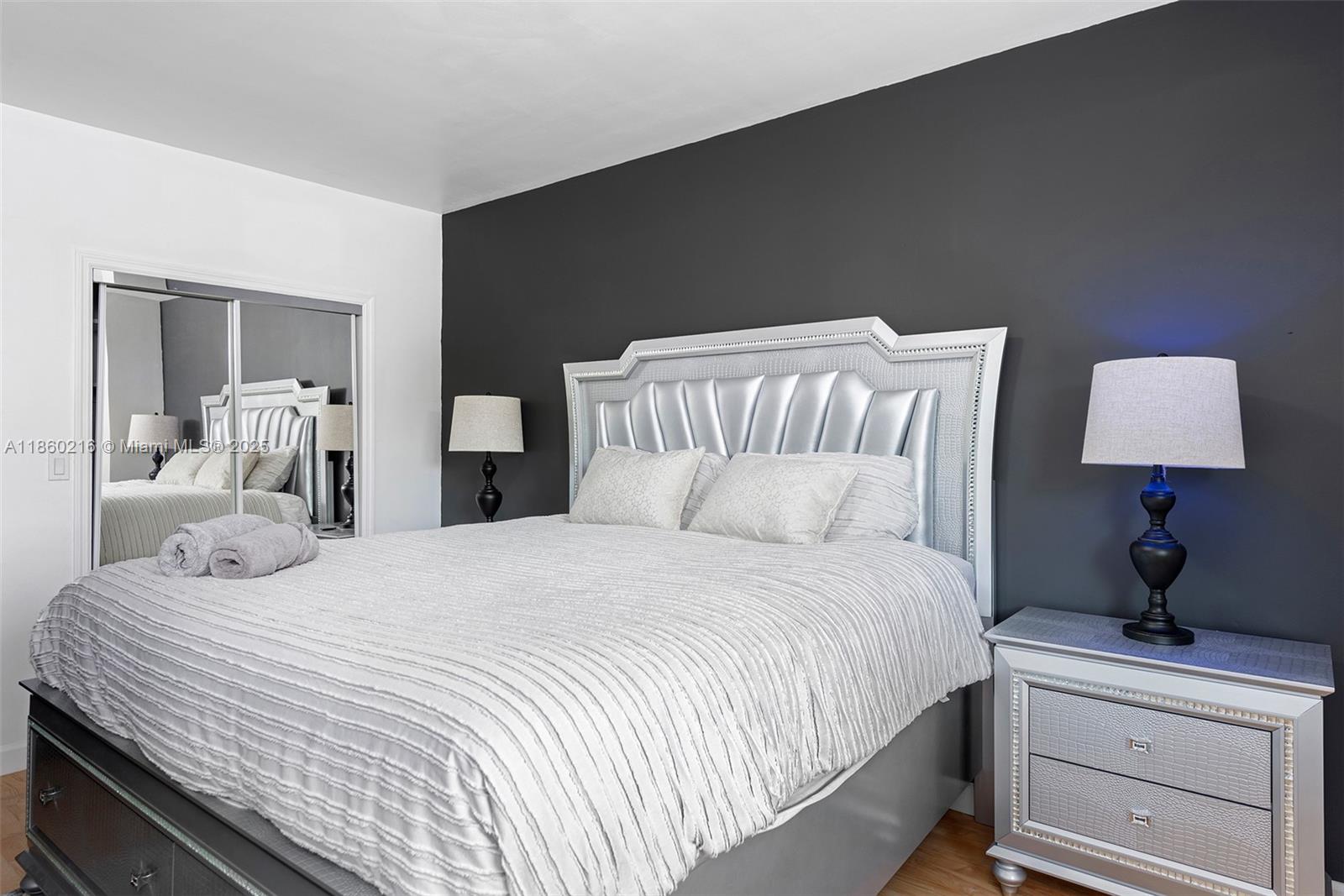 250 Northeast 158th Street Miami, FL 33162 - Photo 30 of 80 a bedroom with a bed and a lamp on dresser