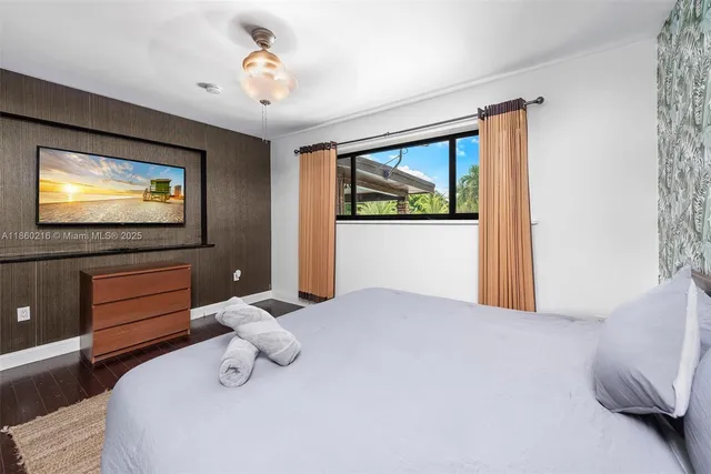 a bedroom with bed and cupboard