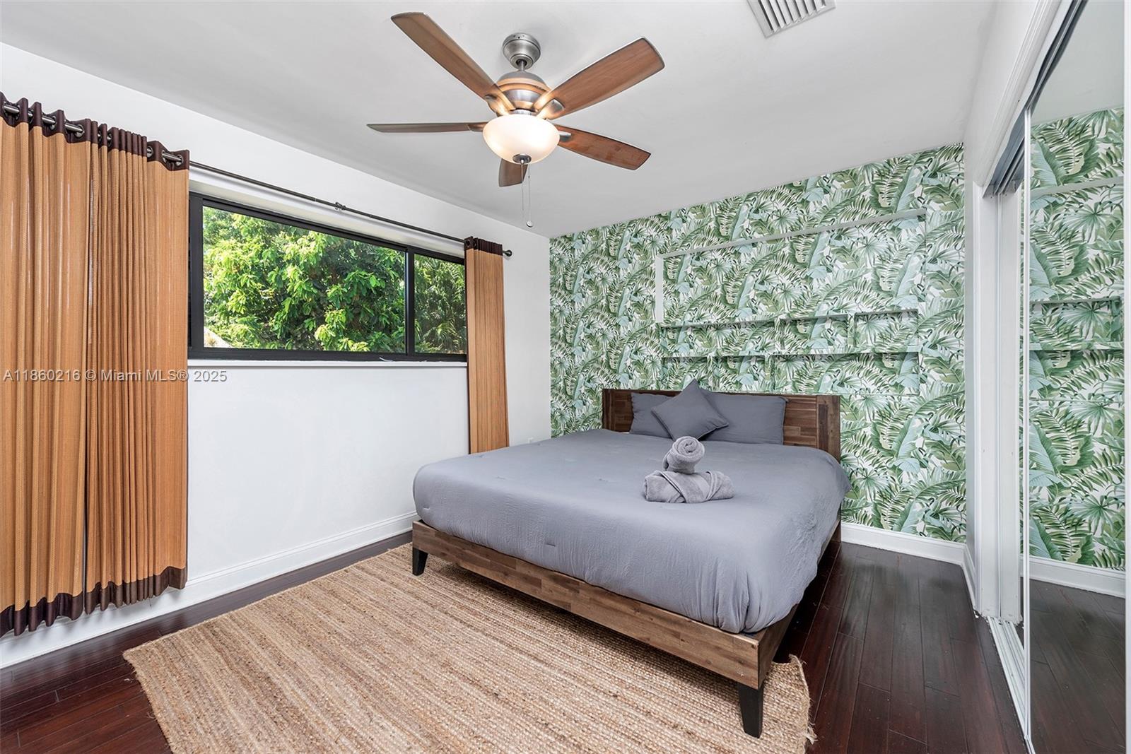 250 Northeast 158th Street Miami, FL 33162 - Photo 33 of 80 a bed sitting in a bedroom next to a window