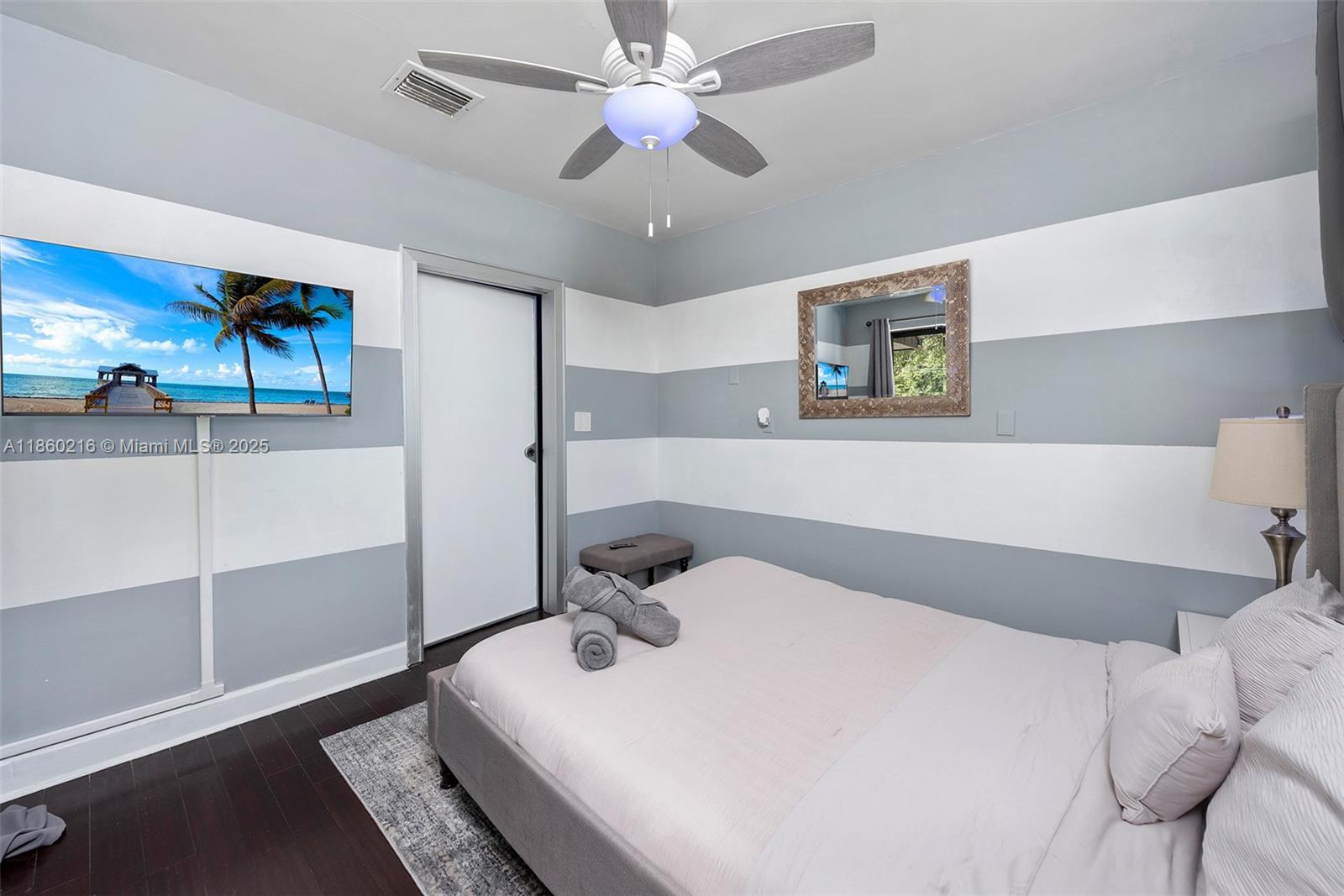 250 Northeast 158th Street Miami, FL 33162 - Photo 37 of 80 a bedroom with a bed and a chandelier