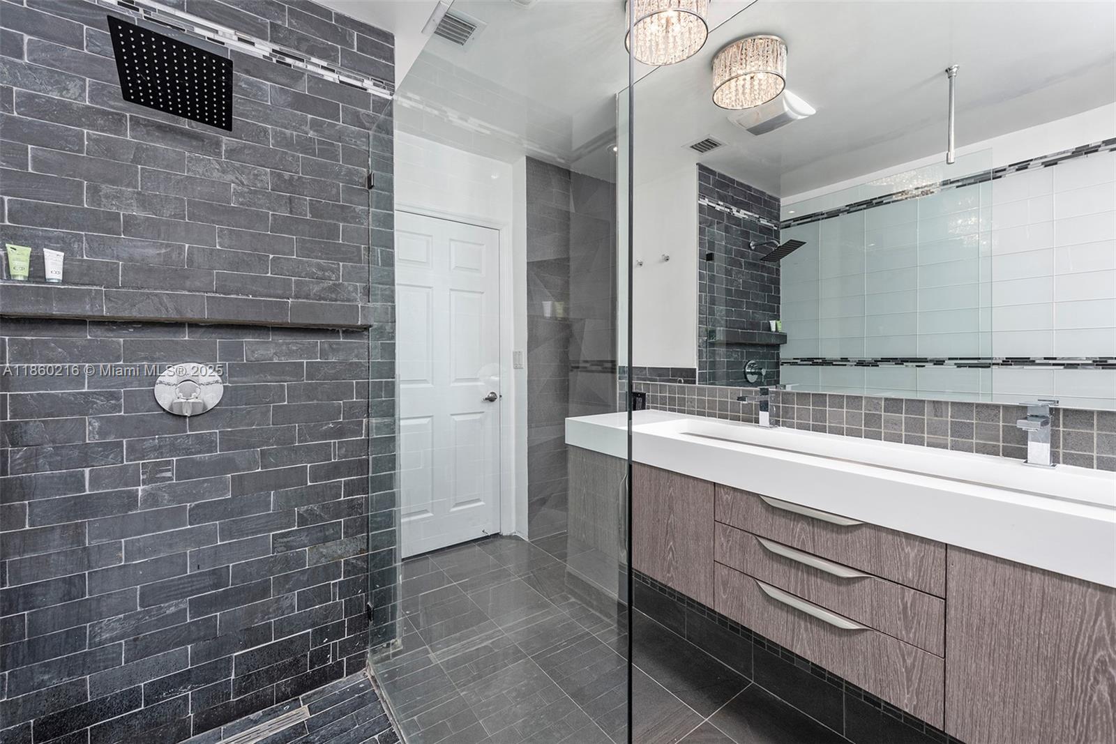 250 Northeast 158th Street Miami, FL 33162 - Photo 39 of 80 a bathroom with a sink and a mirror