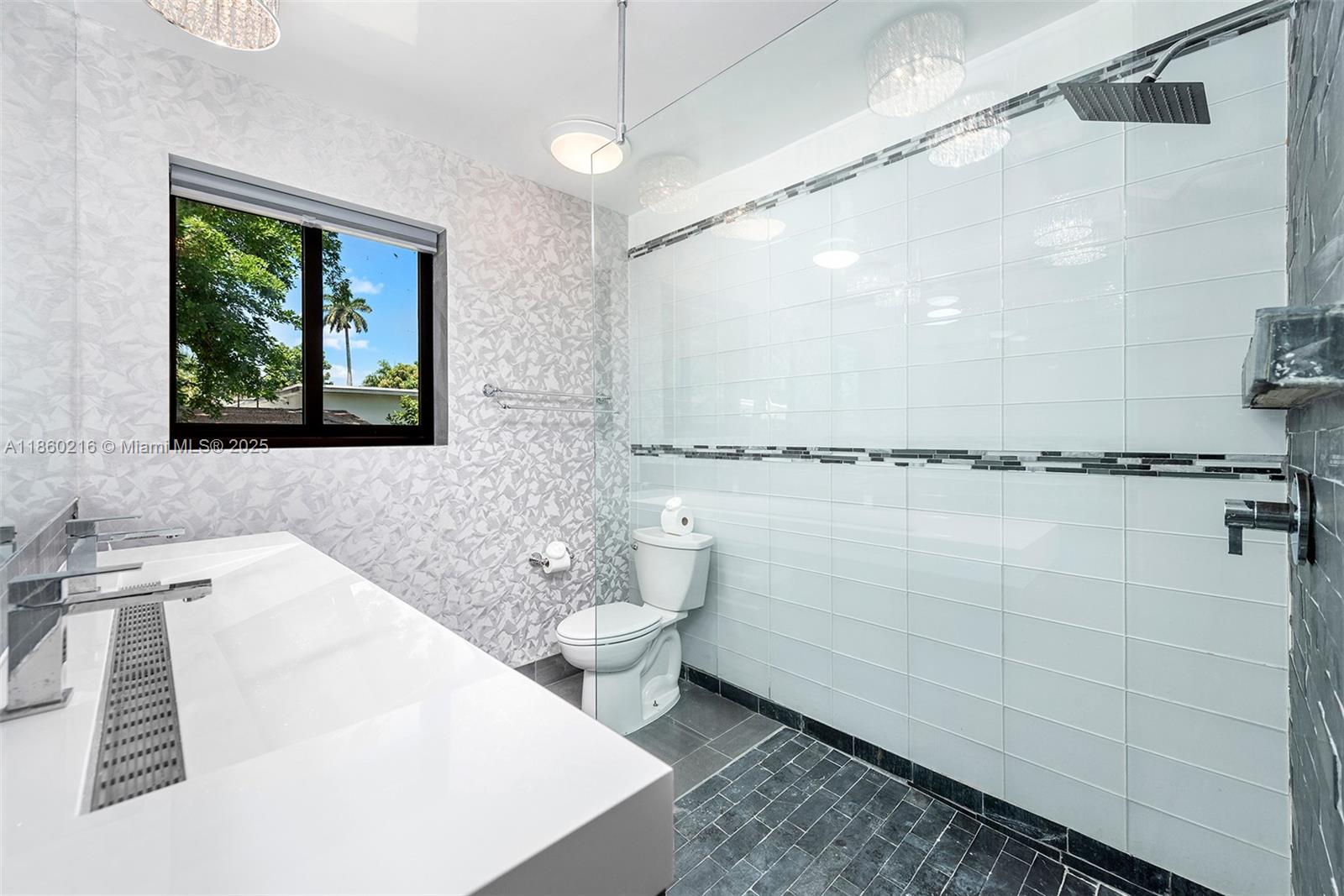 250 Northeast 158th Street Miami, FL 33162 - Photo 40 of 80 a bathroom with a sink a toilet and shower