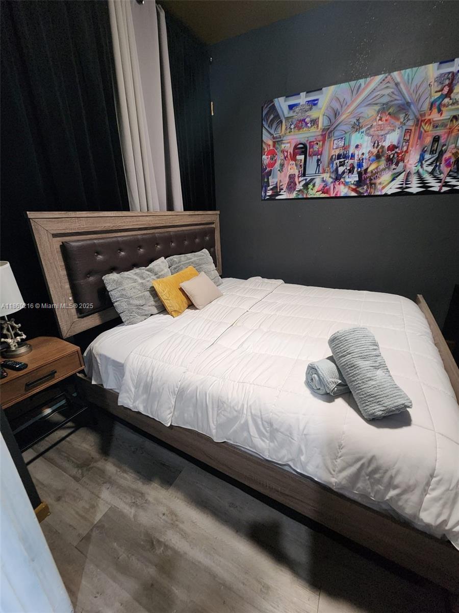 250 Northeast 158th Street Miami, FL 33162 - Photo 43 of 80 a bedroom with bed and cupboard